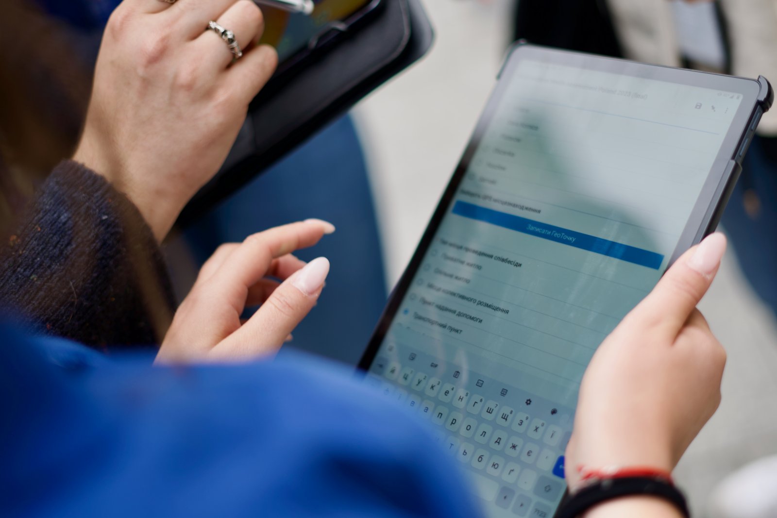 A staff member records data on a tablet in the field